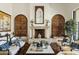 Comfortable living room featuring a cozy fireplace, stylish seating arrangements, and elegant decor at 6640 E Kasba Cir, Paradise Valley, AZ 85253