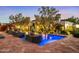 Beautiful pool featuring illuminated blue water and stone planters at 6640 E Kasba Cir, Paradise Valley, AZ 85253