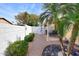 Private backyard featuring a covered patio, gravel landscaping, and mature palm trees at 6730 E Hermosa Vista Dr # 20, Mesa, AZ 85215