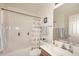 Well-maintained bathroom featuring a shower-tub combo, a large mirror, and neutral finishes at 6730 E Hermosa Vista Dr # 20, Mesa, AZ 85215