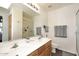 Double sink bathroom featuring updated fixtures, a large mirror, and a glass-enclosed shower for easy living at 6730 E Hermosa Vista Dr # 20, Mesa, AZ 85215