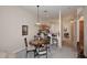 A cozy dining area with a round table, complemented by the adjacent breakfast bar and an open view of other rooms at 6730 E Hermosa Vista Dr # 20, Mesa, AZ 85215