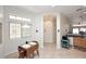 A dining space enhanced by abundant natural light and neutral tones, complete with a view into the adjacent kitchen at 6730 E Hermosa Vista Dr # 20, Mesa, AZ 85215