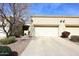 The home's exterior featuring a driveway, garage and desert landscaping, reflecting a blend of functionality and natural beauty at 6730 E Hermosa Vista Dr # 20, Mesa, AZ 85215