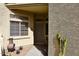 Inviting front entryway with a security door, desert landscaping, and a charming outdoor accent at 6730 E Hermosa Vista Dr # 20, Mesa, AZ 85215