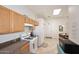 Well-lit kitchen featuring gas range, ample cabinet space, and a skylight for natural lighting at 6730 E Hermosa Vista Dr # 20, Mesa, AZ 85215