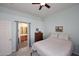 Bright bedroom with a ceiling fan and adjoining bathroom, featuring neutral paint and light carpet at 6730 E Hermosa Vista Dr # 20, Mesa, AZ 85215