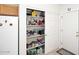 Walk-in pantry featuring abundant shelving for optimal storage, complemented by sliding doors and adjacent refrigerator at 6730 E Hermosa Vista Dr # 20, Mesa, AZ 85215