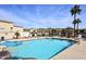 Community pool with clear blue water, surrounded by lounge chairs and well-maintained landscaping, creating a relaxing oasis at 6730 E Hermosa Vista Dr # 20, Mesa, AZ 85215