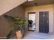 Condo entrance with a view into the unit, featuring a gated door and a potted plant at 7009 E Acoma Dr # 1113, Scottsdale, AZ 85254