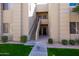 Exterior of a condo building showing multiple units, stairwells, and well-manicured landscaping at 7009 E Acoma Dr # 1113, Scottsdale, AZ 85254
