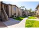 Exterior view of a condo building showcasing well-maintained landscaping and convenient access to stairwells at 7009 E Acoma Dr # 1113, Scottsdale, AZ 85254