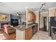 Updated kitchen with granite counters, stainless steel appliances, and an adjoining living space at 7009 E Acoma Dr # 1113, Scottsdale, AZ 85254