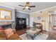 Comfortable living room with a ceiling fan, fireplace, and stylish tile coffee table at 7009 E Acoma Dr # 1113, Scottsdale, AZ 85254