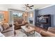 Inviting living room featuring a fireplace, ceiling fan, and sliding doors to a balcony at 7009 E Acoma Dr # 1113, Scottsdale, AZ 85254