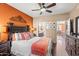 Comfortable main bedroom with wooden floors, a ceiling fan, and ensuite bathroom and kitchen views at 7009 E Acoma Dr # 1113, Scottsdale, AZ 85254
