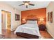 Comfortable main bedroom with wooden floors, a ceiling fan, and ensuite bathroom access at 7009 E Acoma Dr # 1113, Scottsdale, AZ 85254