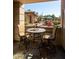 Condo patio features a table and chairs, perfect for enjoying the community pool views at 7009 E Acoma Dr # 1113, Scottsdale, AZ 85254