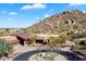 Scenic aerial shot of a property showcasing unique architecture, desert landscaping, and stunning mountain views at 7370 E Sunset Sky Cir, Scottsdale, AZ 85266