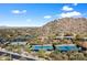 Aerial view showcasing tennis courts and desert landscape, with blue skies at 7370 E Sunset Sky Cir, Scottsdale, AZ 85266