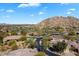 Aerial view of a residential neighborhood with well-maintained homes, desert landscaping, and a backdrop of scenic mountain views at 7370 E Sunset Sky Cir, Scottsdale, AZ 85266