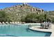 Inviting community pool with lounge chairs and views of the surrounding landscape at 7370 E Sunset Sky Cir, Scottsdale, AZ 85266