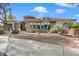 Beautiful Southwestern home with desert landscaping, neutral tones and eye-catching architectural details at 7370 E Sunset Sky Cir, Scottsdale, AZ 85266