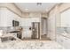 White cabinets, stainless appliances, and granite countertops highlight this well-appointed kitchen in a neutral color palette at 7370 E Sunset Sky Cir, Scottsdale, AZ 85266