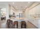Bright kitchen with white cabinets, stainless steel appliances, granite countertops, and a breakfast bar with seating at 7370 E Sunset Sky Cir, Scottsdale, AZ 85266