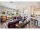 Spacious living room with fireplace, comfortable leather sofa, and seamless flow to kitchen at 7370 E Sunset Sky Cir, Scottsdale, AZ 85266