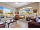 Relaxing living room showcasing a fireplace, comfortable sofa, and large windows with outdoor scenery at 7370 E Sunset Sky Cir, Scottsdale, AZ 85266