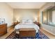 Well-lit main bedroom with wood flooring, large window, and a king bed flanked by matching bedside tables at 7370 E Sunset Sky Cir, Scottsdale, AZ 85266