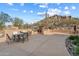 Outdoor patio featuring a built-in grill, seating, and desert landscaping at 7370 E Sunset Sky Cir, Scottsdale, AZ 85266
