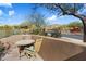 Backyard patio with wooden table and chairs overlooking desert foliage at 7370 E Sunset Sky Cir, Scottsdale, AZ 85266