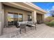 Covered patio featuring tiled flooring, comfortable seating, and desert views, perfect for outdoor relaxation and entertaining at 7370 E Sunset Sky Cir, Scottsdale, AZ 85266