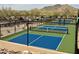 View of well-maintained pickleball courts with blue and green surfaces and mountain views at 7370 E Sunset Sky Cir, Scottsdale, AZ 85266