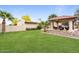 Expansive backyard featuring a cabana, lush lawn, and desert landscaping perfect for outdoor living and entertaining at 7820 S Maple Ave, Tempe, AZ 85284