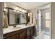 Bathroom featuring double sink vanity, and an illuminated mirror with modern light fixture at 7820 S Maple Ave, Tempe, AZ 85284