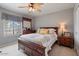 Bright bedroom with a ceiling fan, large window with curtains, and wooden furniture at 7820 S Maple Ave, Tempe, AZ 85284