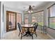Bright dining area with tile floor, ceiling fan, and views through a glass paneled door at 7820 S Maple Ave, Tempe, AZ 85284