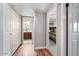 Hallway leading to bedrooms and bathroom featuring hardwood flooring and ample closet space at 7820 S Maple Ave, Tempe, AZ 85284