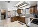 Traditional kitchen featuring stainless steel appliances, mosaic backsplash, and bright natural lighting at 7820 S Maple Ave, Tempe, AZ 85284