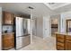 Spacious kitchen features stainless steel refrigerator and views into the laundry and dining areas at 7820 S Maple Ave, Tempe, AZ 85284