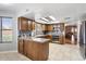 Bright kitchen featuring wood cabinets, tile floors, and modern appliances at 7820 S Maple Ave, Tempe, AZ 85284