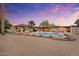 Relaxing backyard oasis with a large covered patio, swimming pool, and desert landscaping at 7820 S Maple Ave, Tempe, AZ 85284