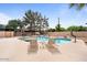 Inviting backyard pool area featuring lounge chairs and a refreshing swimming pool for relaxing on a sunny day at 7820 S Maple Ave, Tempe, AZ 85284