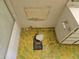 Candid view of the bathroom floor featuring green retro tiling, peeling paint and a missing toilet at 7940 E Camelback Rd # 712, Scottsdale, AZ 85251