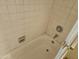 Close up of the bathtub featuring tile, an old faucet, and a sliding glass door at 7940 E Camelback Rd # 712, Scottsdale, AZ 85251