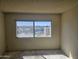 Empty bedroom with a large window overlooking a city with lush greenery at 7940 E Camelback Rd # 712, Scottsdale, AZ 85251