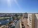 Scenic view of a pond with a fountain, a parking lot, and apartment buildings in the background at 7940 E Camelback Rd # 712, Scottsdale, AZ 85251